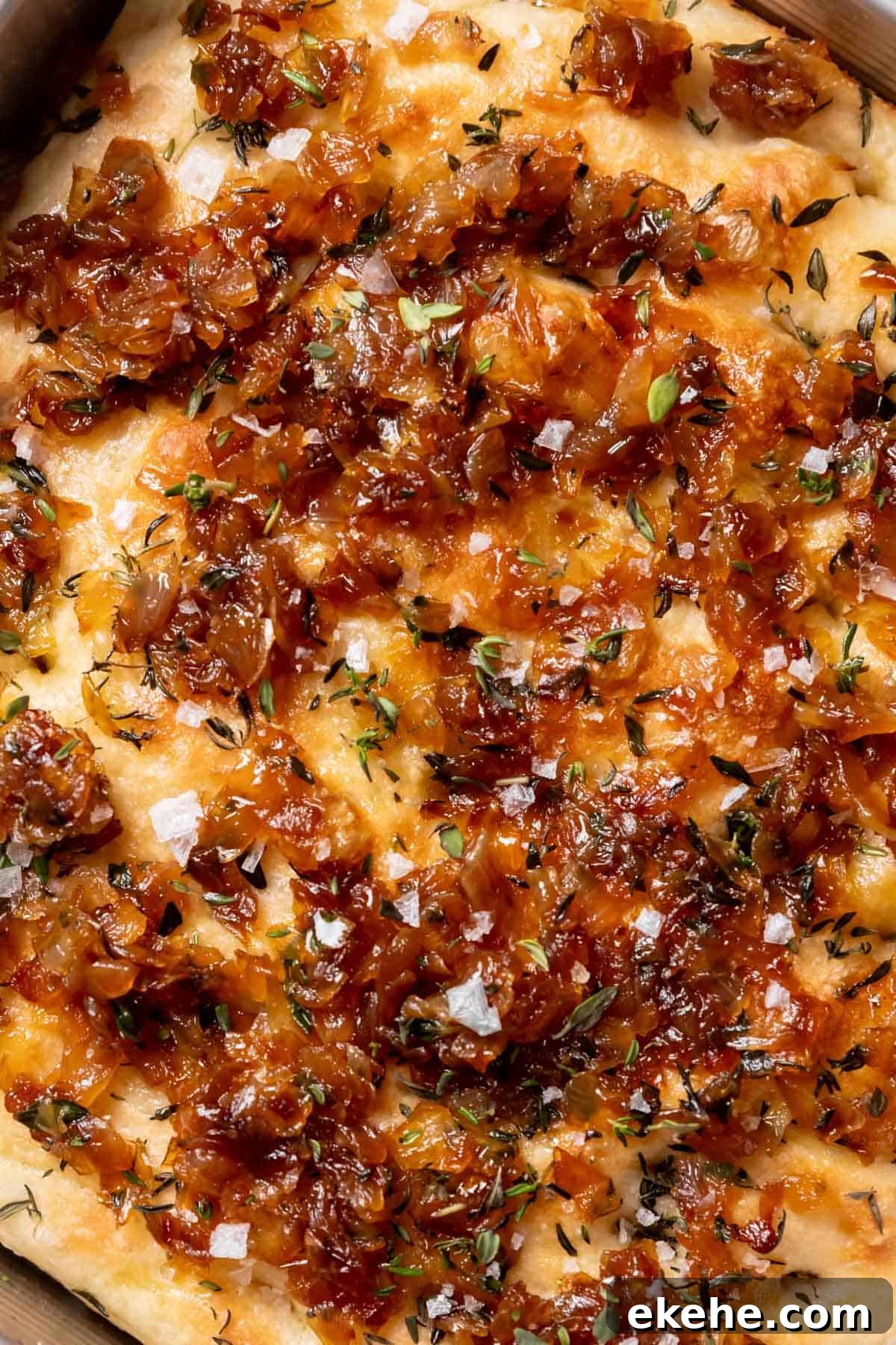 focaccia with caramelized onions, fresh thyme, and flaky sea salt on top.