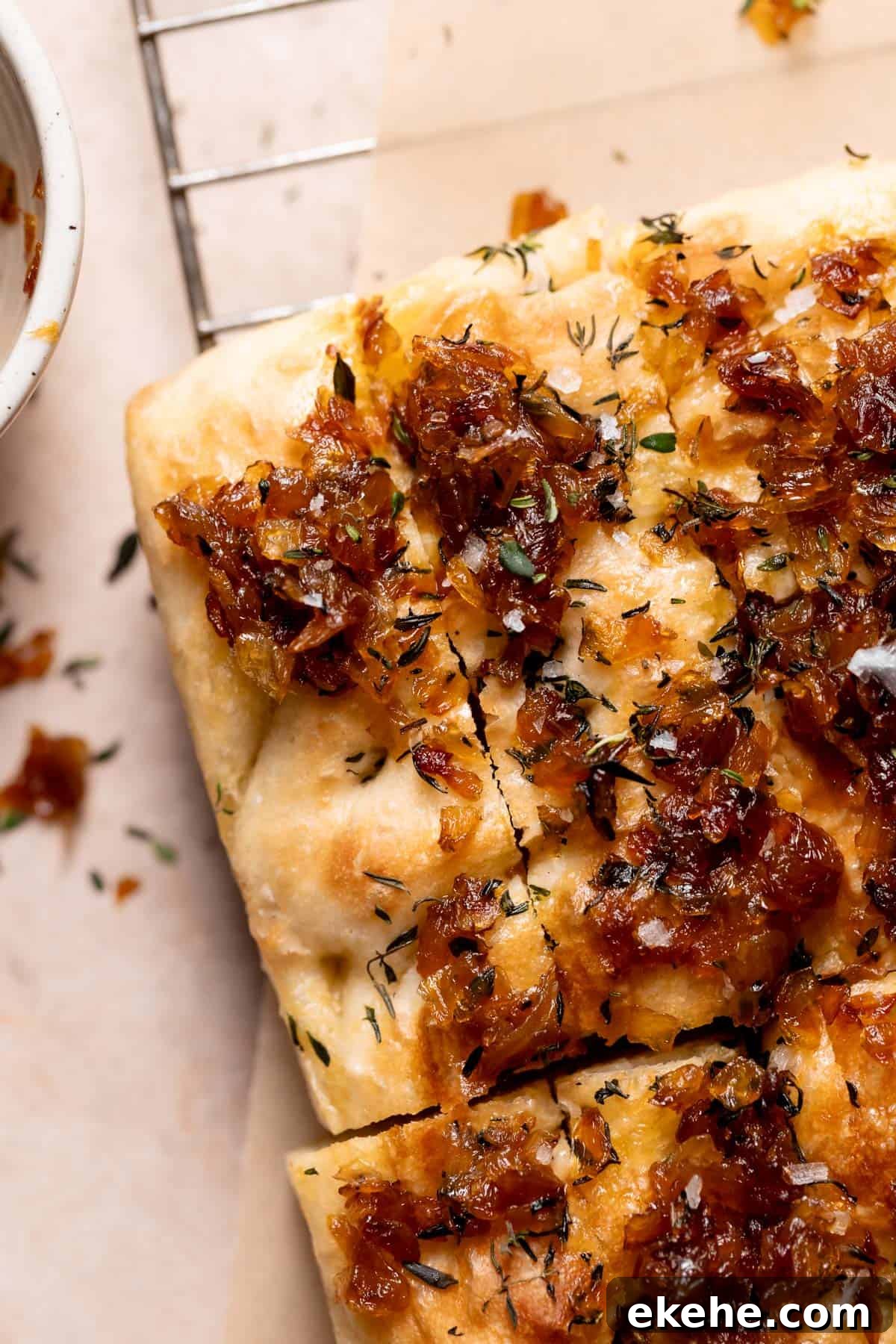 french onion focaccia on a wire cooling rack.