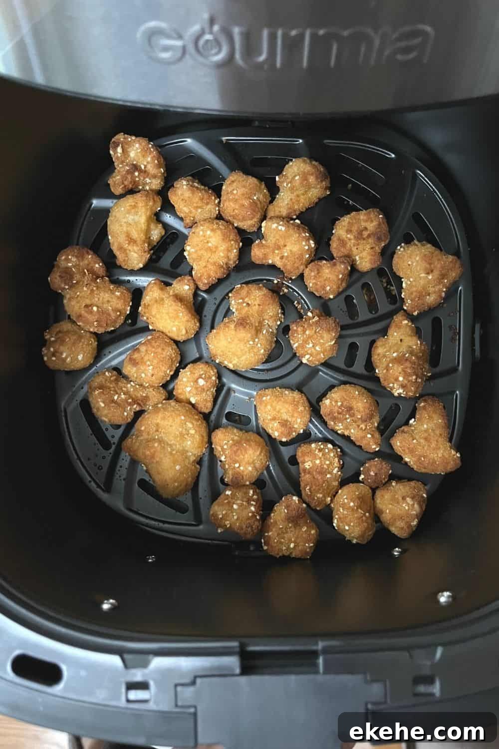 cooked cauliflower wings in the basket of an air fryer