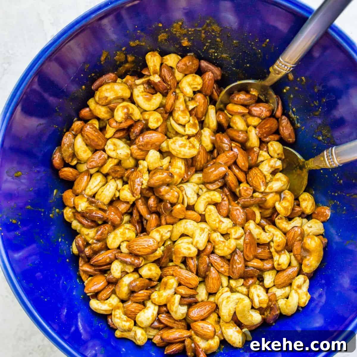 Sweet Curry-Glazed Cashews & Almonds: Spiced Snack Recipe 5 Almonds and cashews in a bowl coated in a curry spice.