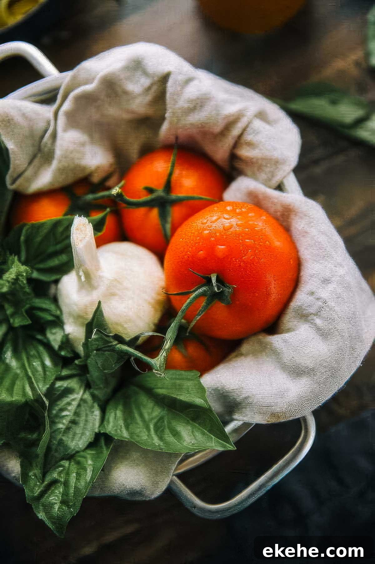 a basket filled with fresh ingredients for authentic italian marinara sauce (tomatoes, basil, and garlic)