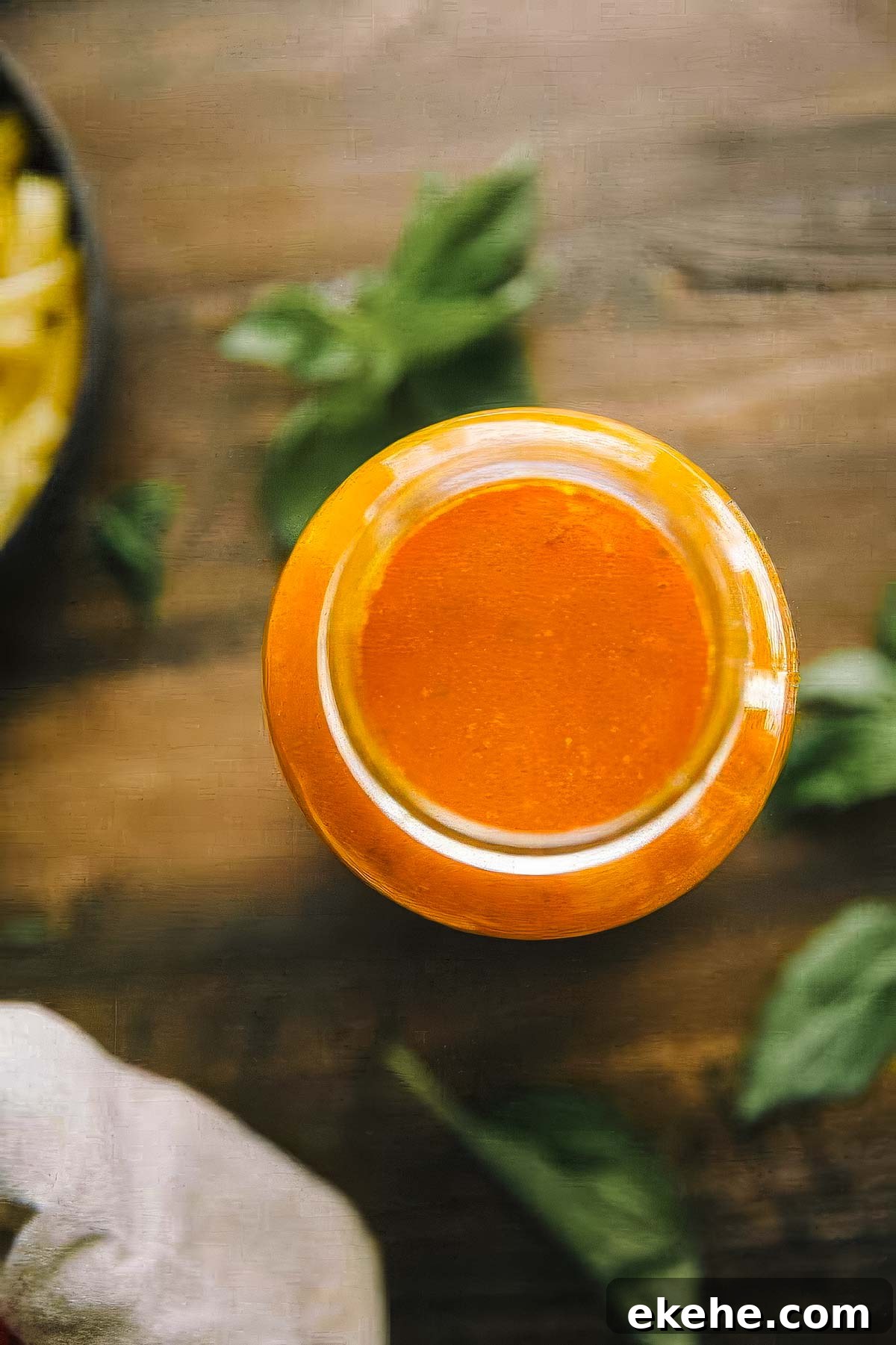 a jar of authentic italian marinara sauce with fresh basil on the table