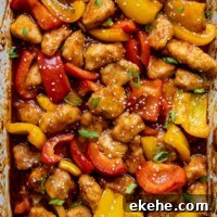 overhead shot of gluten free sweet and sour chicken in a white baking dish