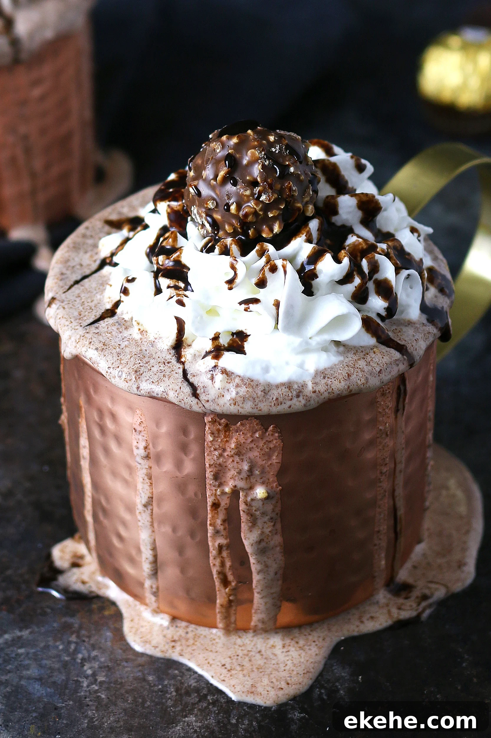 1 milkshake in a copper mug with Ferrero rocher candies in the background