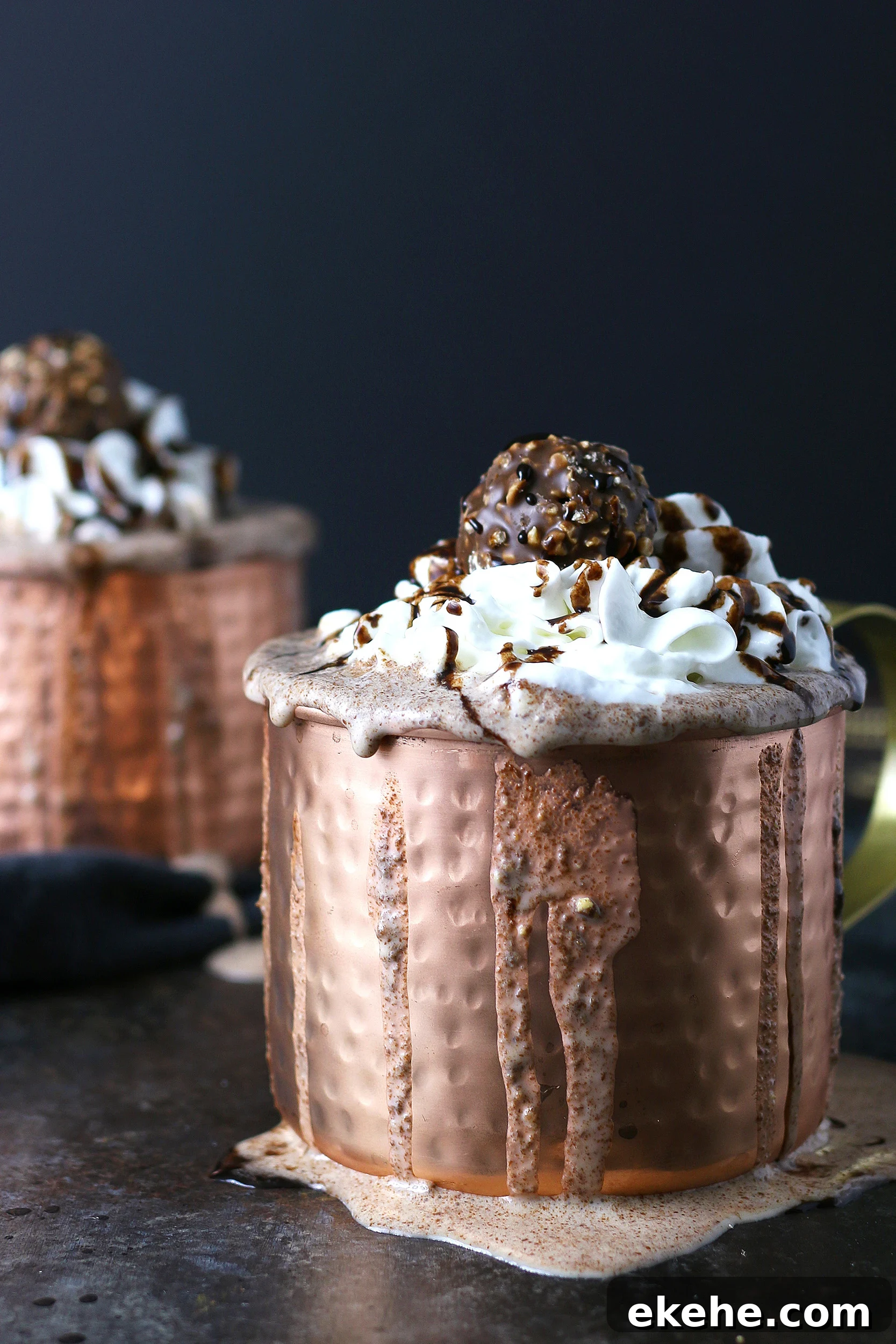 two copper mugs filled with Ferrero rocher Nutella milkshakes