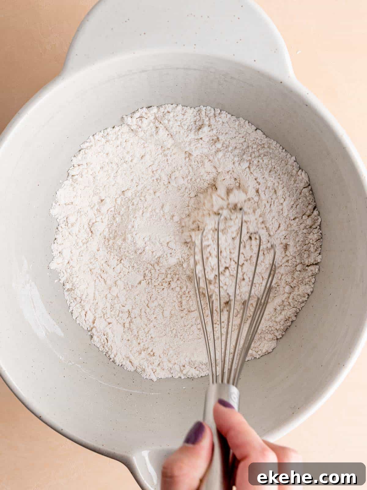 Whisking all purpose flour, granulated sugar, salt, and baking powder in a bowl.