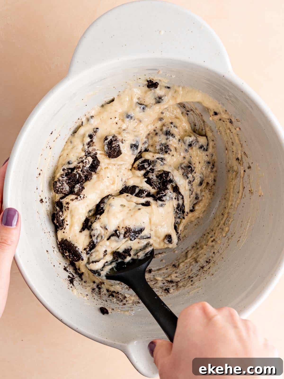 Folding crushed Oreos into vanilla donut batter.