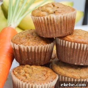 stack of banana carrot muffins with a carrot on the side and bananas in the background