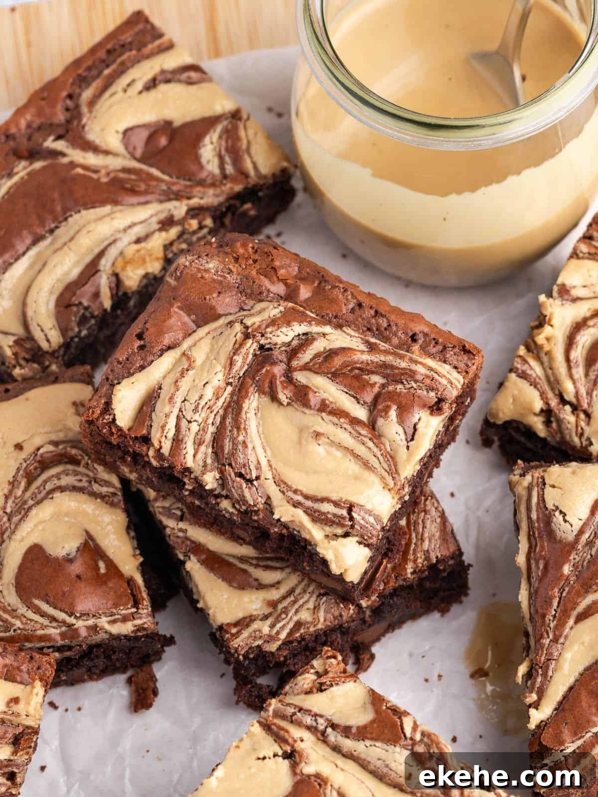 A stack of tahini brownies on parchment paper.