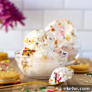 A scoop of Funfetti Golden Oreo Ice Cream in a glass dessert bowl.