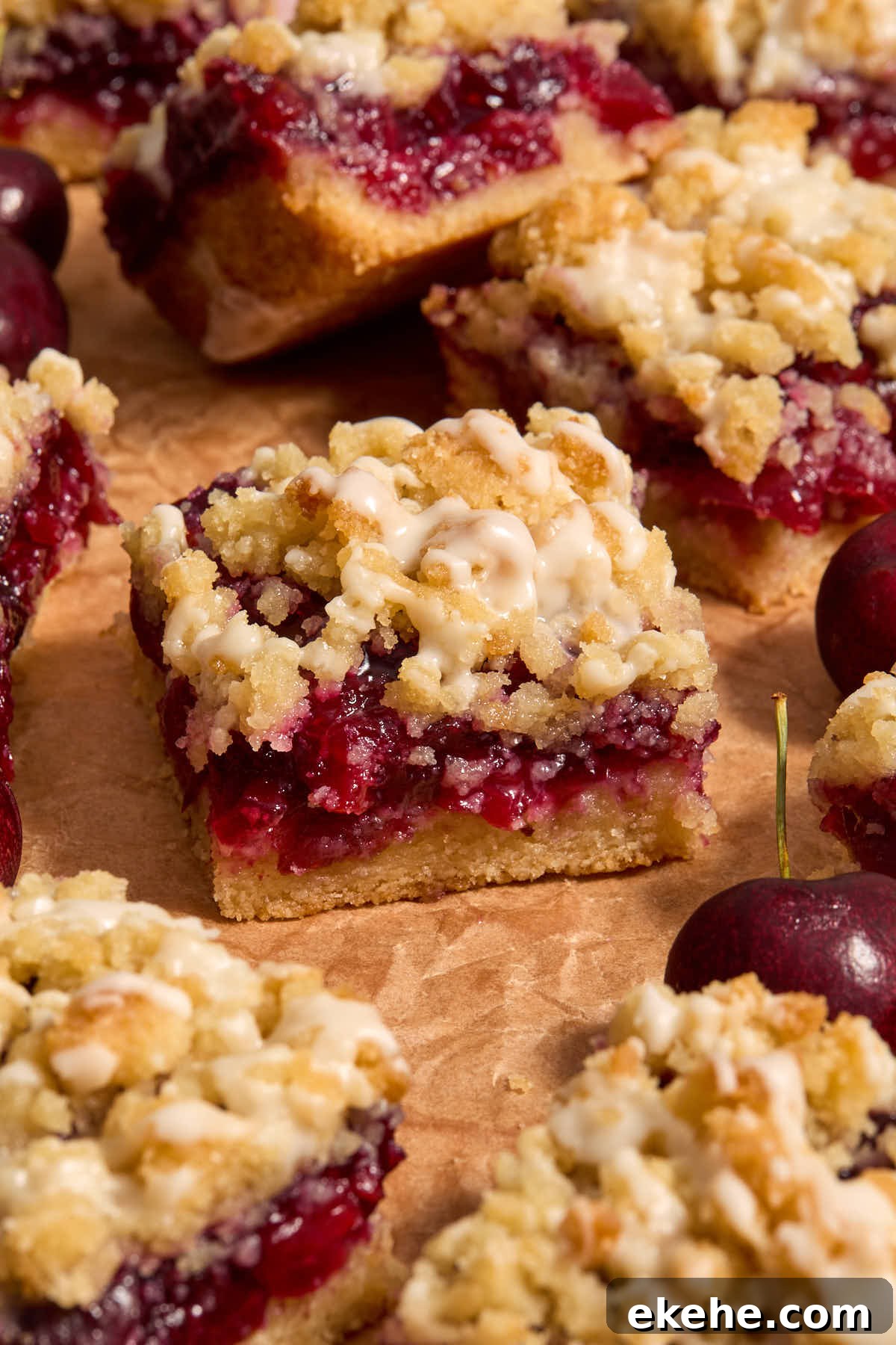 Side view of cherry bars on a sheet of brown parchment.