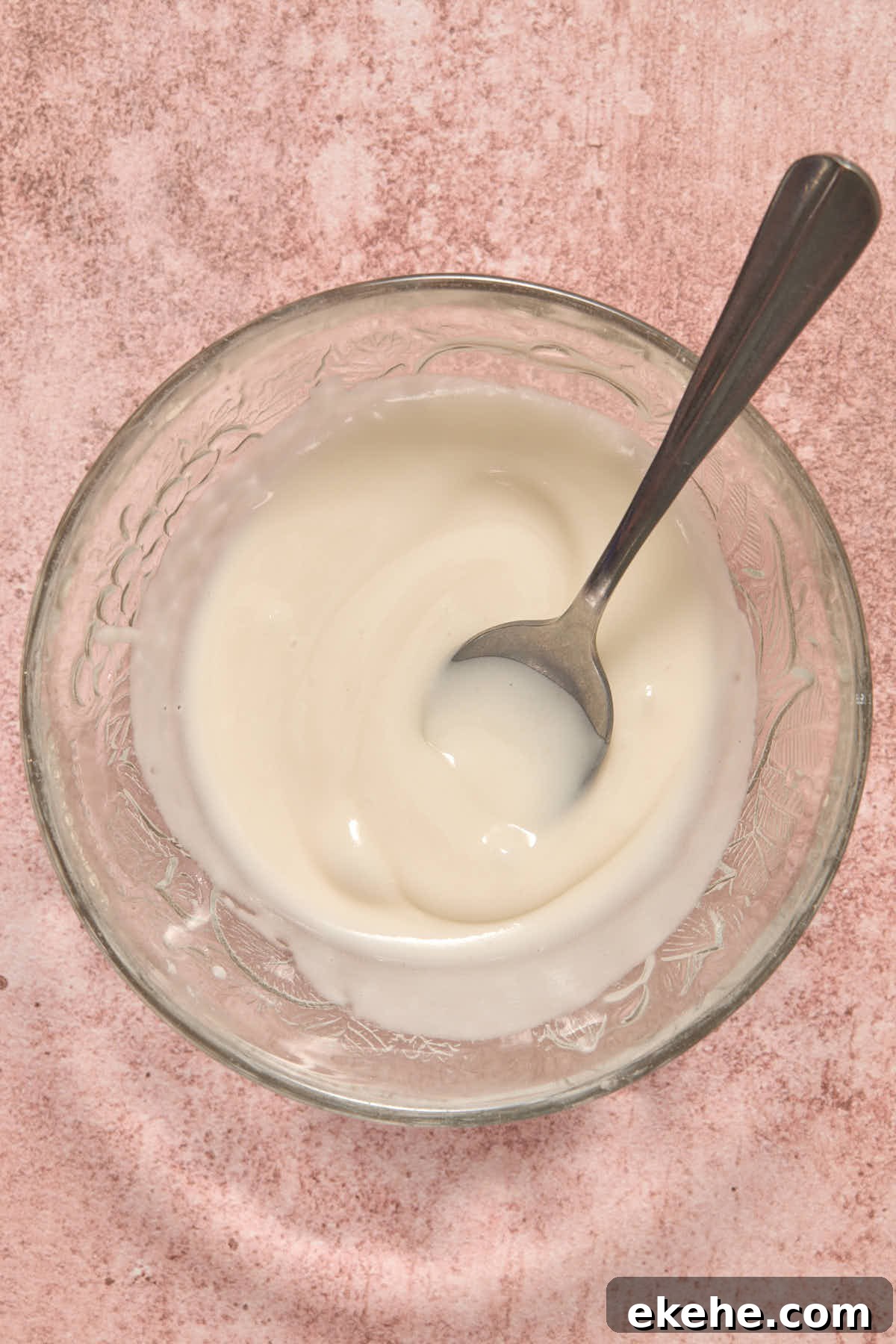 Powdered sugar glaze mixed together in a small glass bowl.