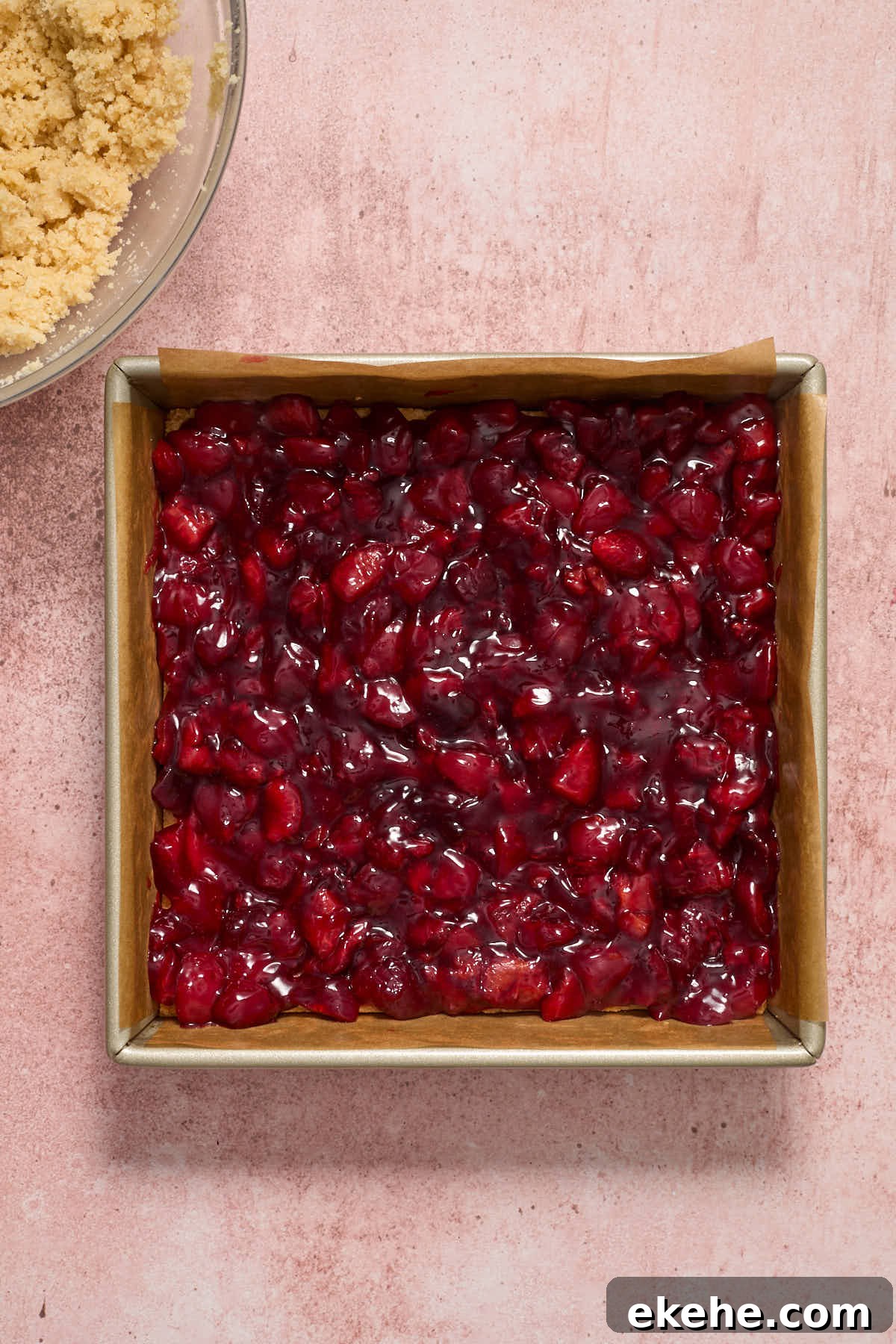 Cherry filling spread out on crust.