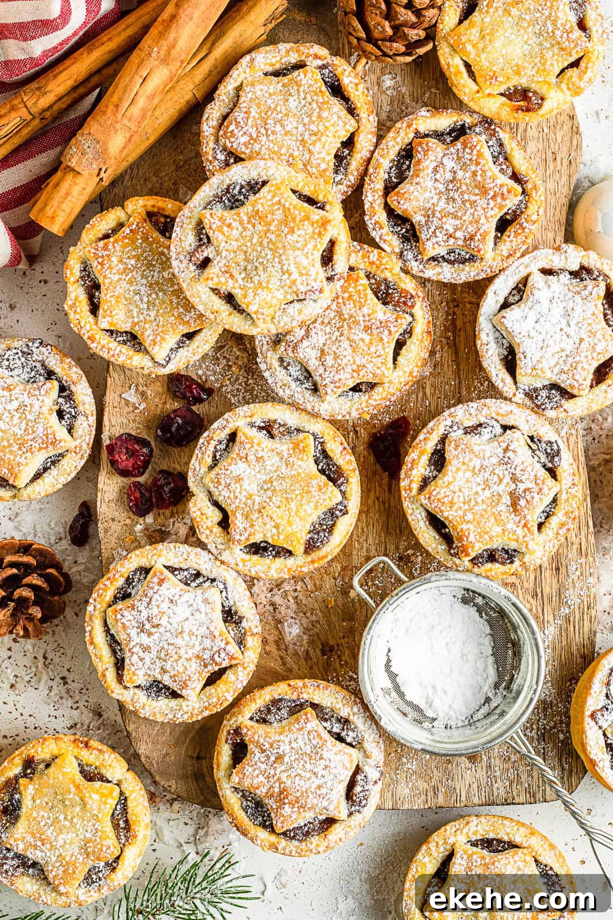 Mini Mincemeat Pies on a board with powdered sugar. 