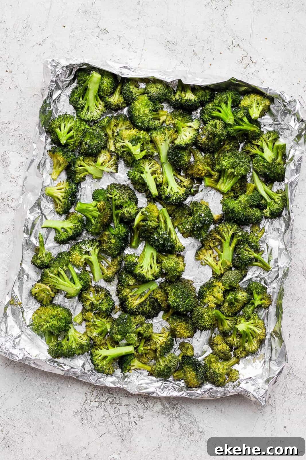 Smoked broccoli in an aluminum foil boat.
