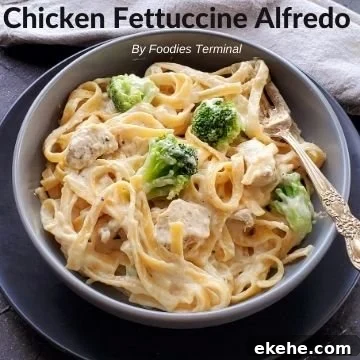 chicken fettuccine alfredo with broccoli in a grey bowl with a fork
