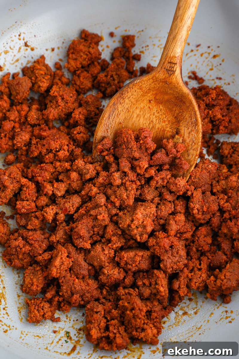 A close up photo of cooked chorizo in a large saute pan