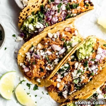 chicken tinga tacos laid out with fresh limes and flaked salt