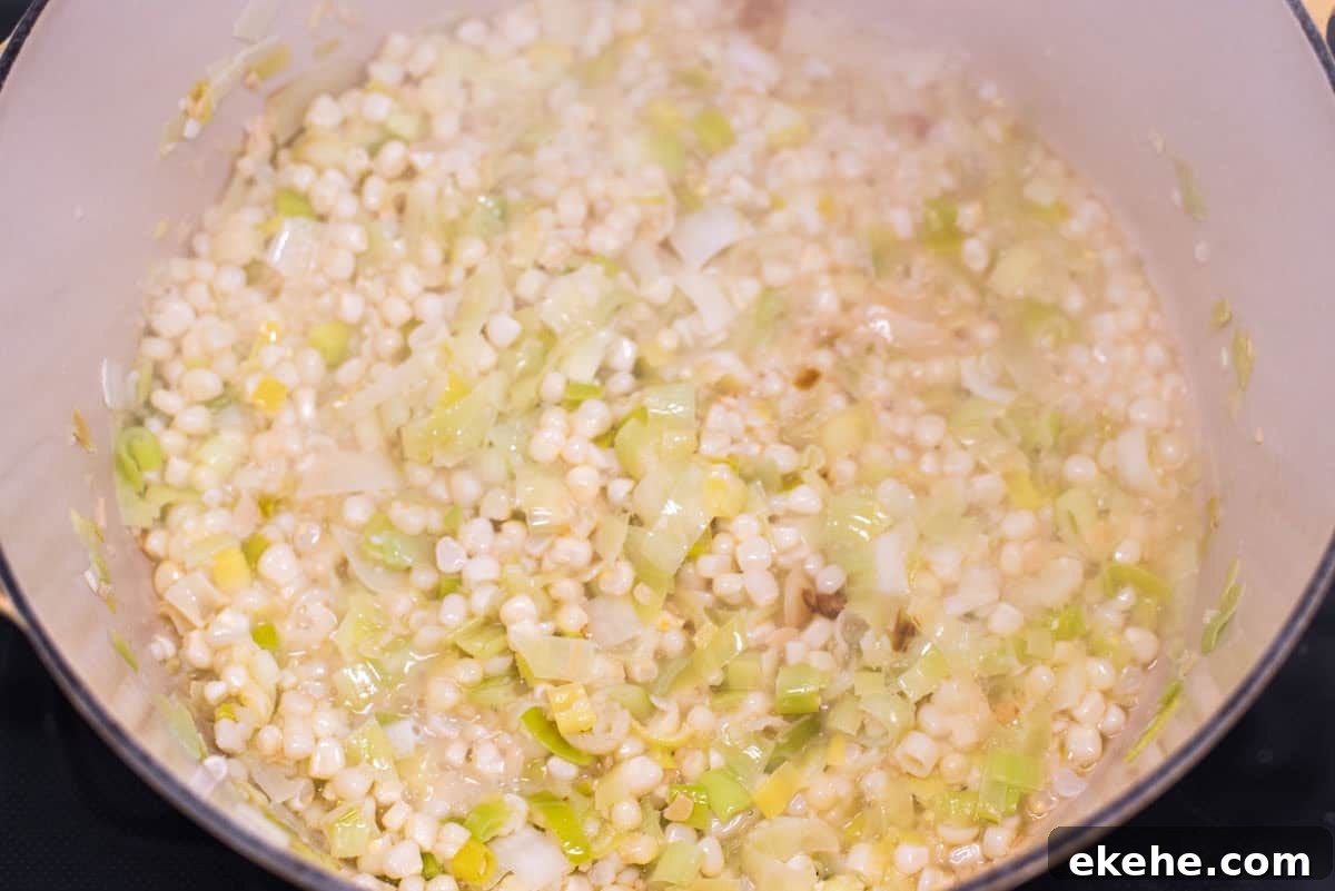 Leeks and corn being deglazed with wine.