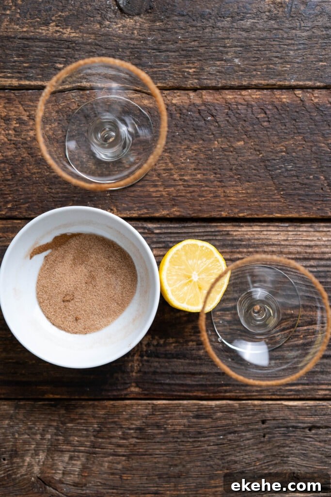adding cinnamon sugar to the rim of two cocktail glasses