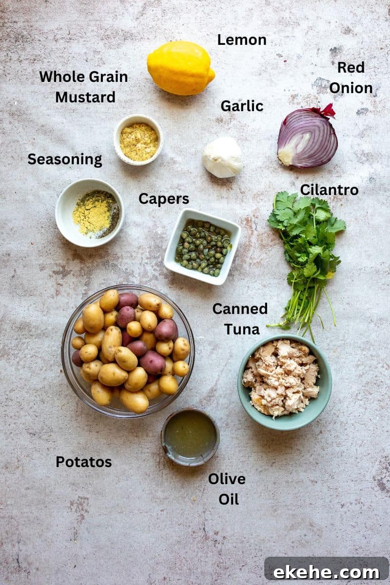 Ingredients needed to make this tuna potato salad on a counter with small bowls. 