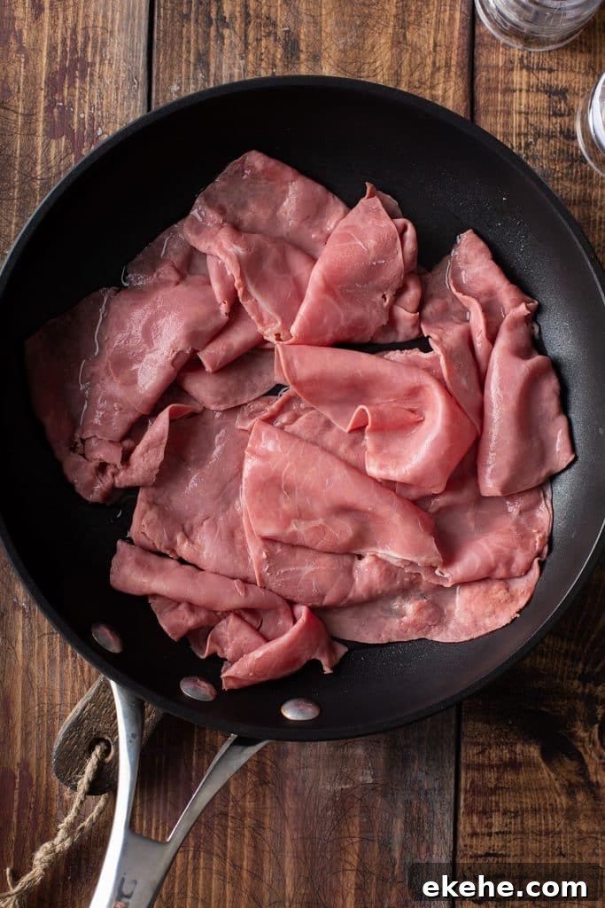warming up slices of corned beef on a skillet