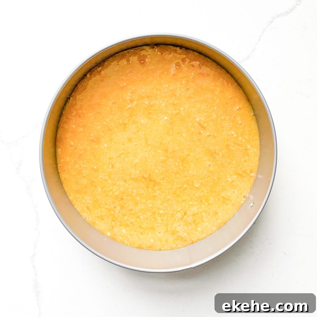 Tunisian cake batter poured into a cake tin.