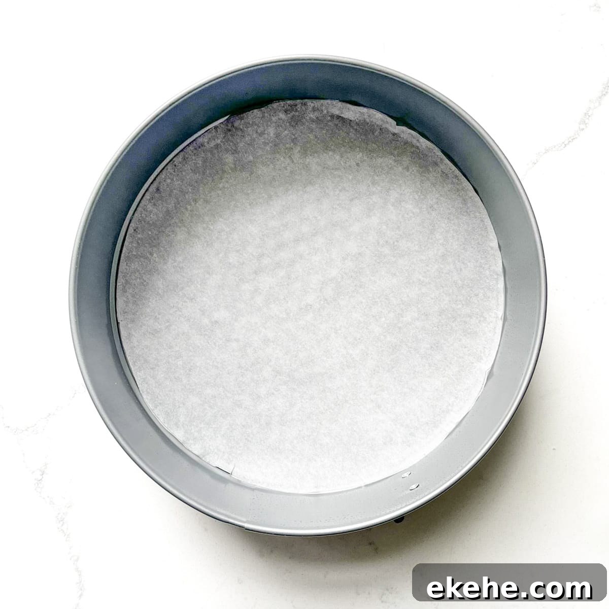 A cake tin lined with parchment paper.