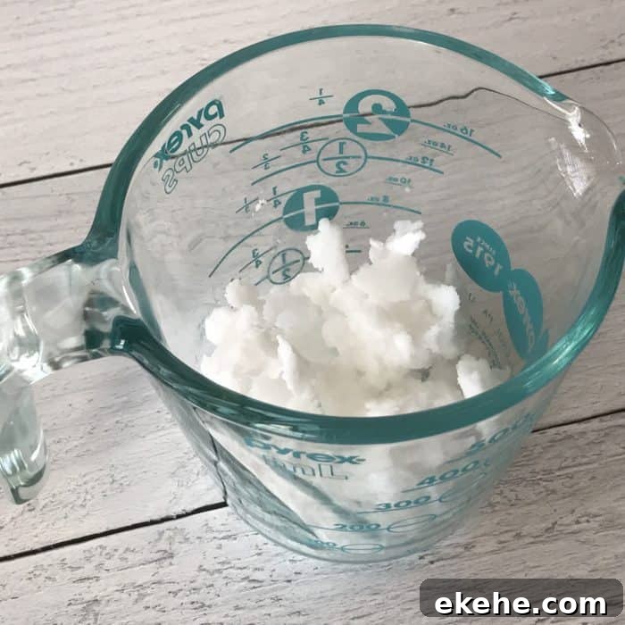 coconut oil in measuring cup