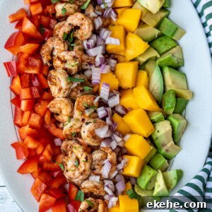 Diced mango, cooked shrimp, avocado, and bell peppers.