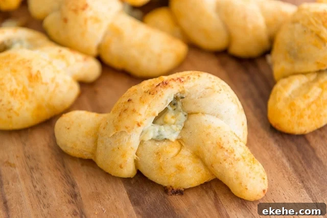 Buffalo Garlic Knot Recipe: Spicy, Cheesy Pull-Apart Rolls 2 Buffalo Garlic Knots on Wooden Board with Blue Cheese Filling