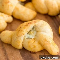 Buffalo Garlic Knot Recipe: Spicy, Cheesy Pull-Apart Rolls 17 Buffalo Garlic Knots on Wooden Board with Blue Cheese Filling