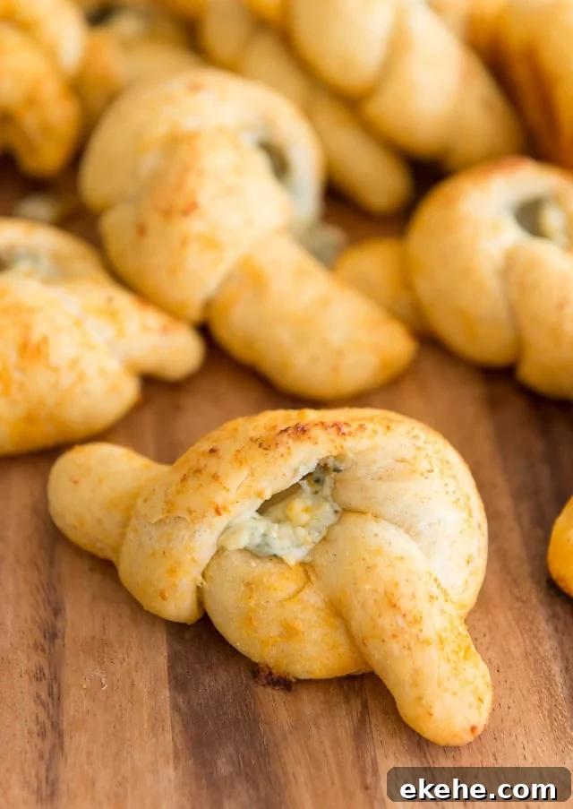 Buffalo Garlic Knot Recipe: Spicy, Cheesy Pull-Apart Rolls 3 Buffalo Garlic Knots Piled on Wooden Board with Blue Cheese Filling