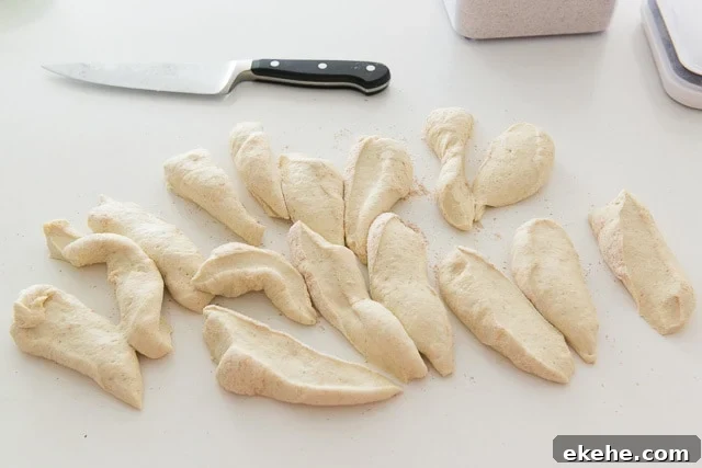 Buffalo Garlic Knot Recipe: Spicy, Cheesy Pull-Apart Rolls 9 Cut Pieces of Pizza Knot Dough on Countertop