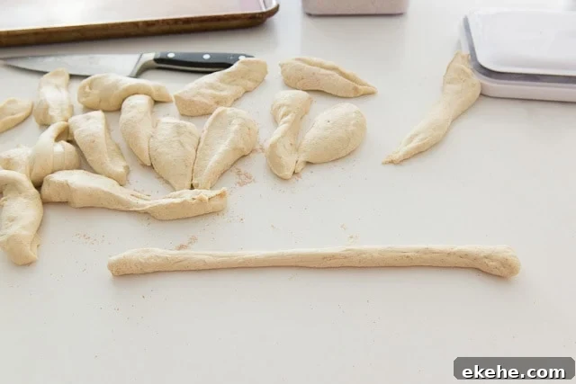 Buffalo Garlic Knot Recipe: Spicy, Cheesy Pull-Apart Rolls 10 Rolled and Cut Pieces of Pizza Knot Dough on Countertop