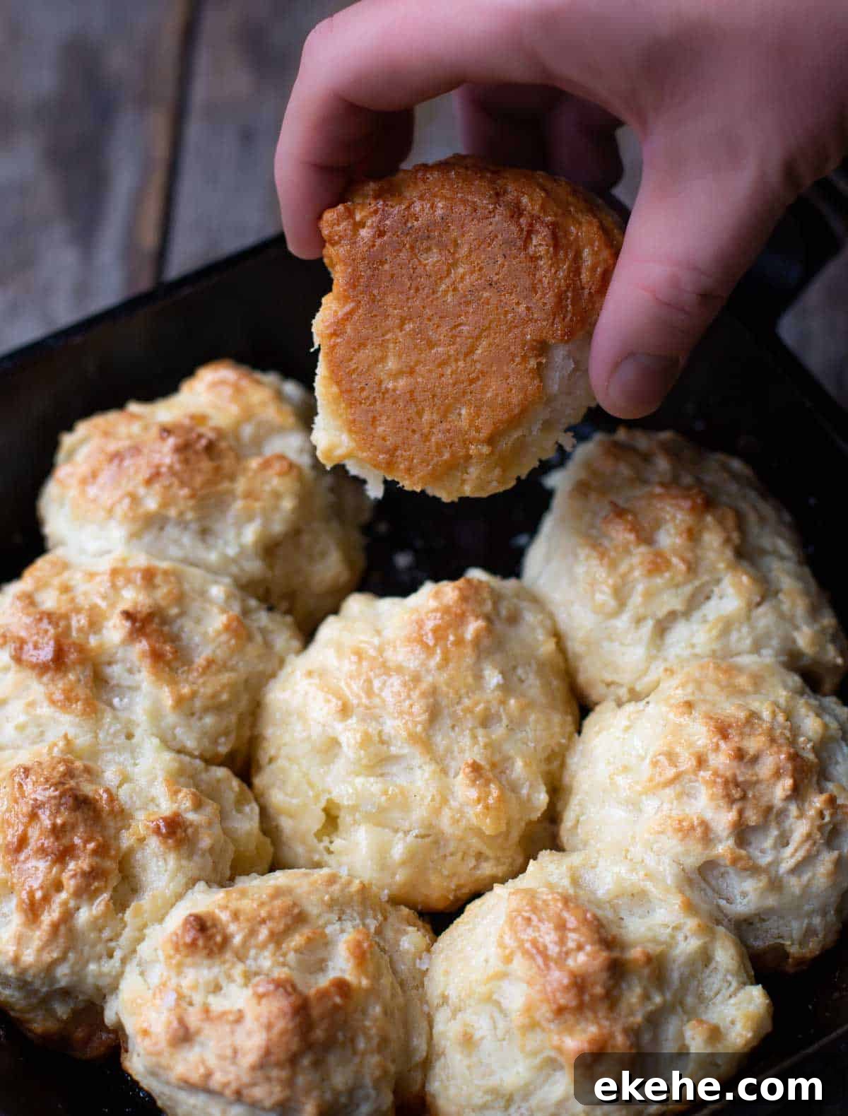 The underside of cast iron drop biscuits showing the golden crust.