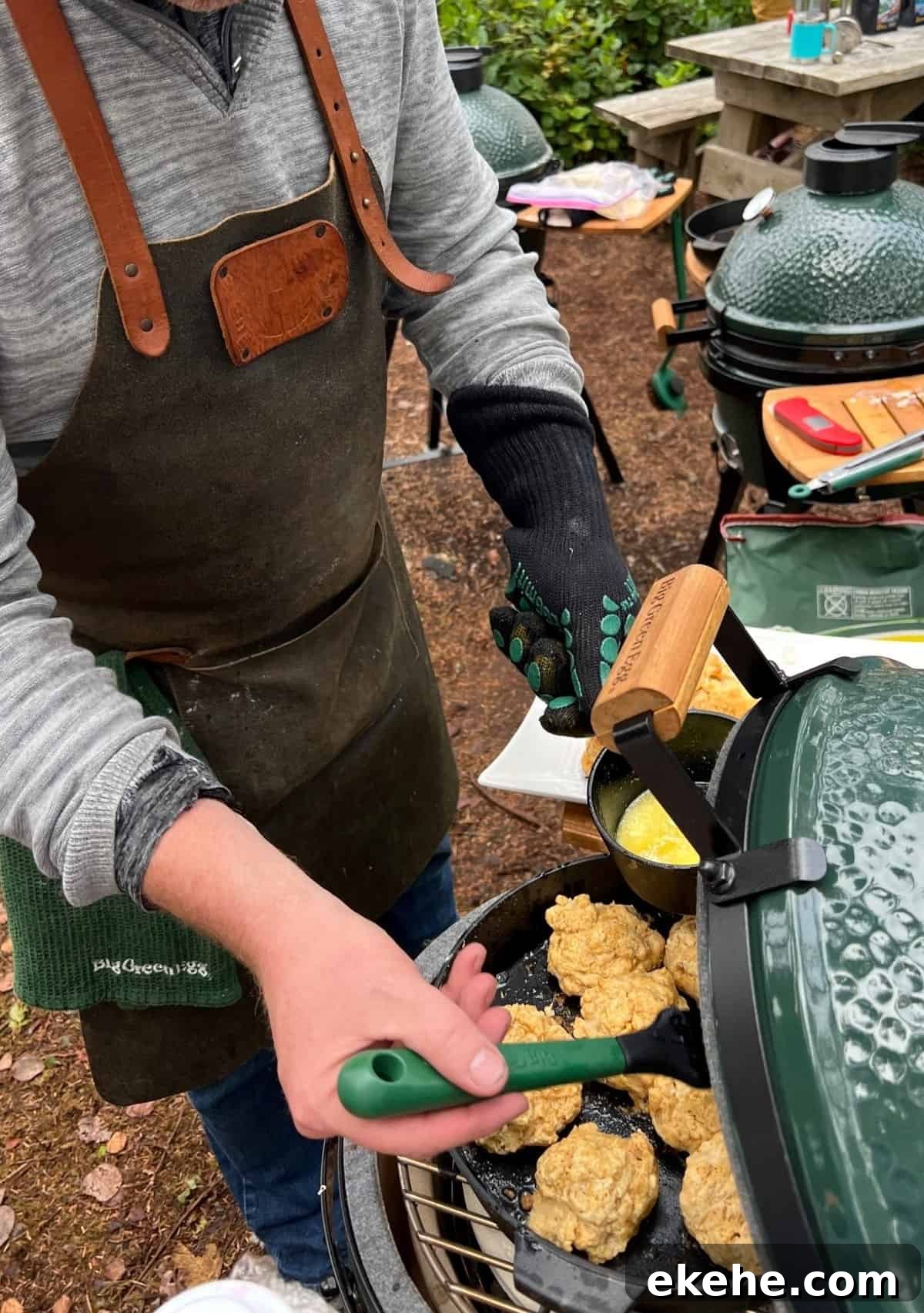 Sean Martin of Vindulge glazing drop biscuits on Big Green Egg with melted butter.