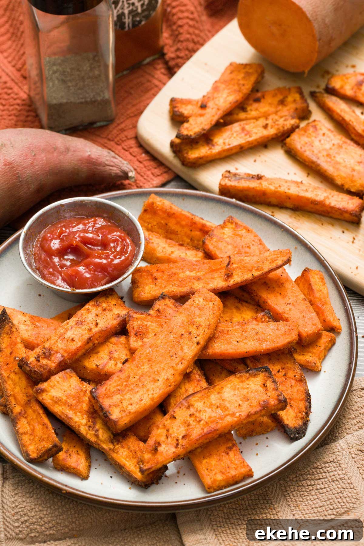 A plate of air fryer sweet potato wedges with ketchup.
