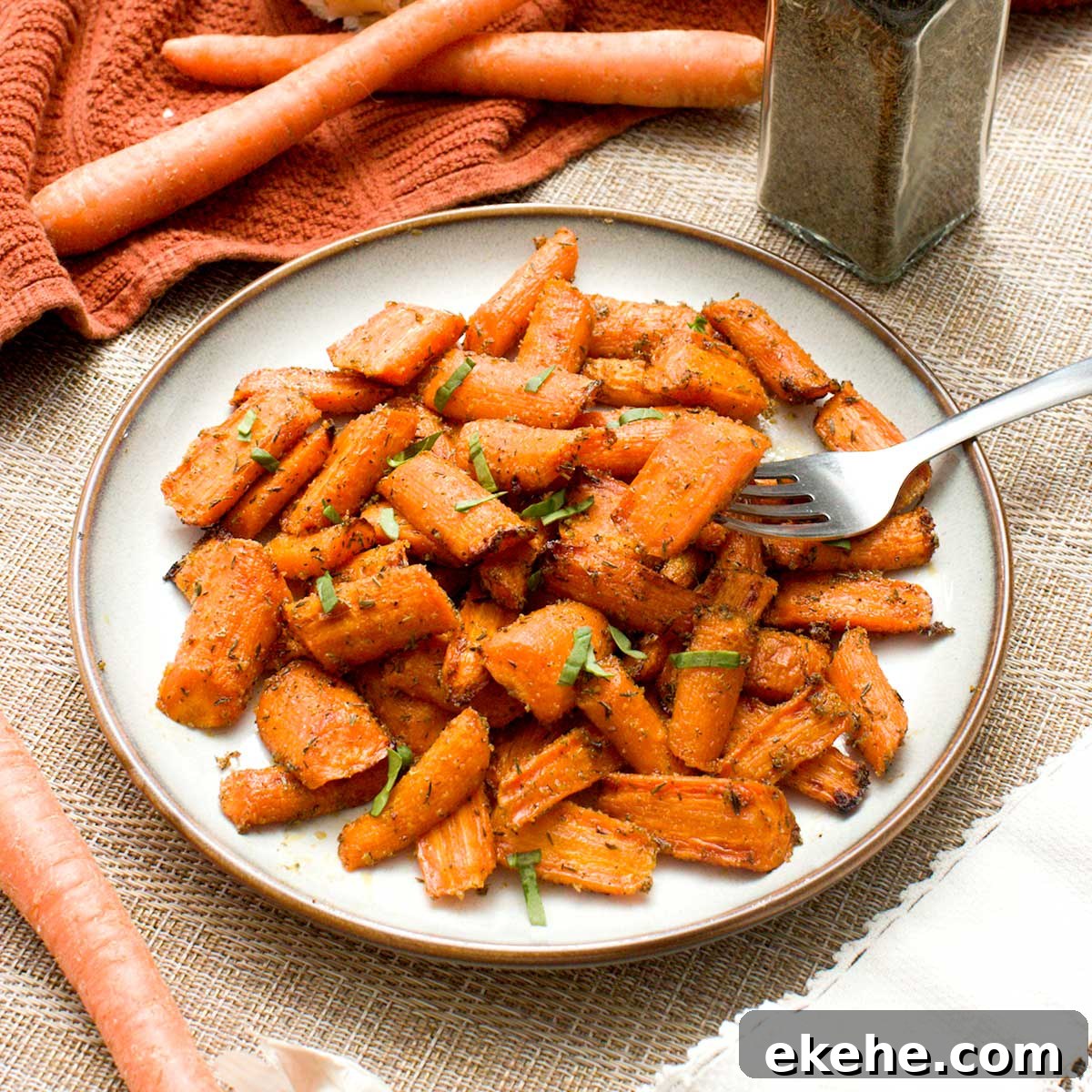 A plate of ealthy maple-glazed carrots cooked in an air fryer or oven.