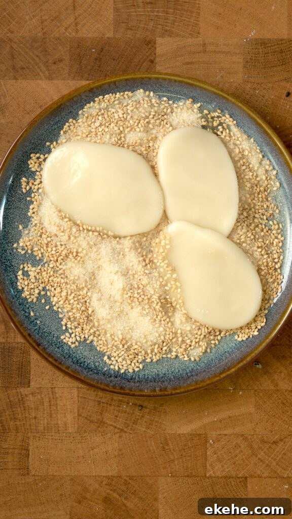 Palitaw drenched in sugar and sesame seeds