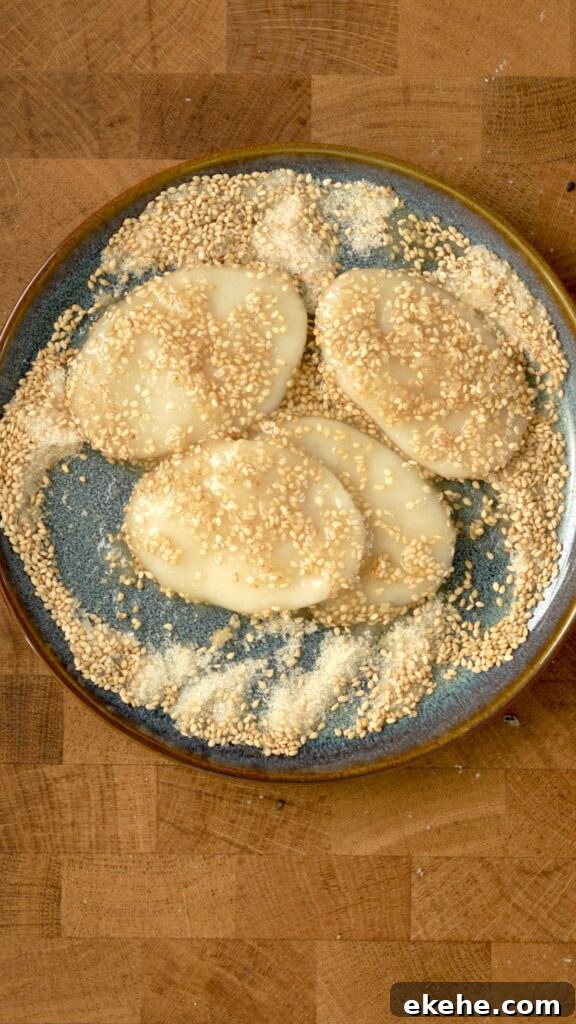 Palitaw fully covered in sugar and sesame seeds