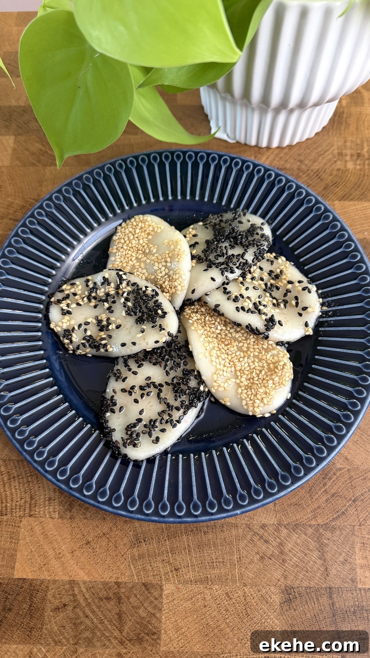 Overhead shot of palitaw covered in black and white sesame seeds