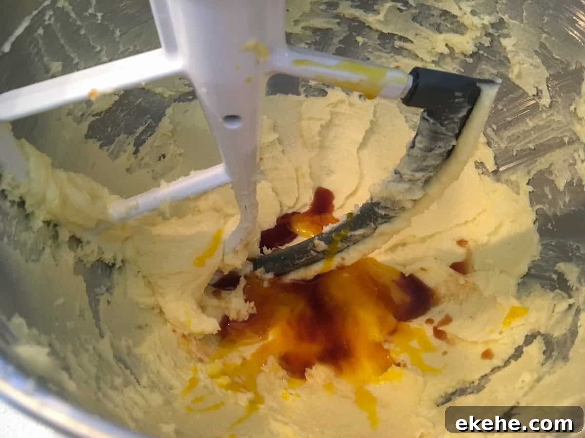 closeup photo of butter, eggs, vanilla and sugar mixed in stand mixer