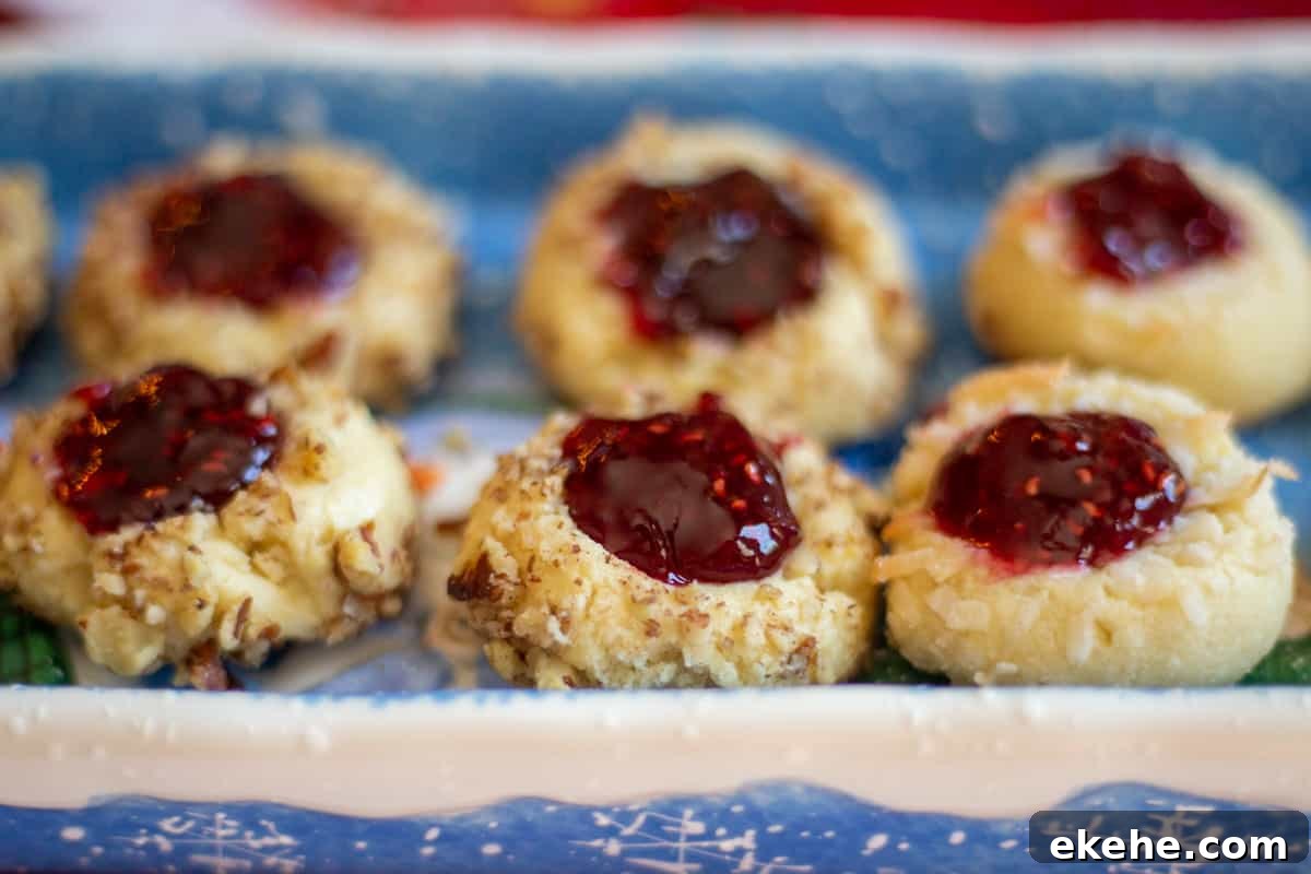 shortbread jam thumbprint cookies on blue and white plate