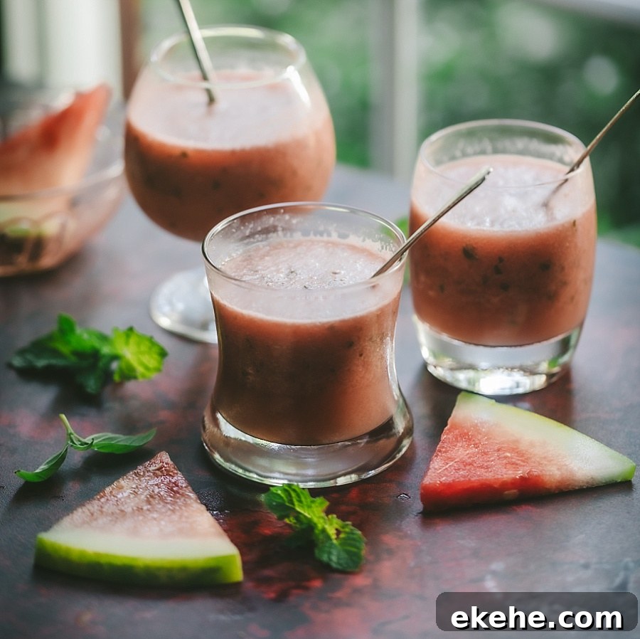 Three glasses of watermelon vodka drinks.