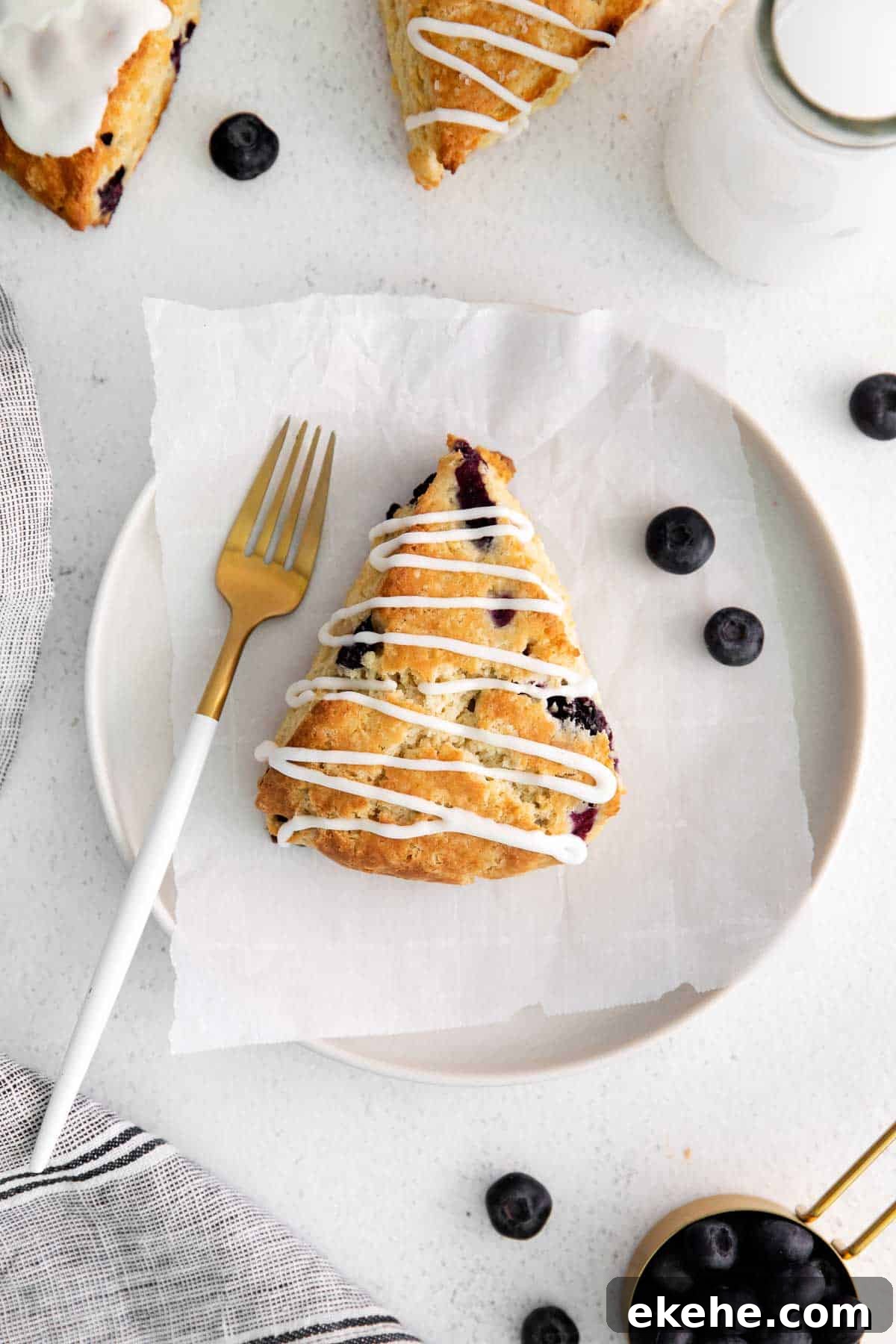 overhead view of a blueberry scone on a plate.
