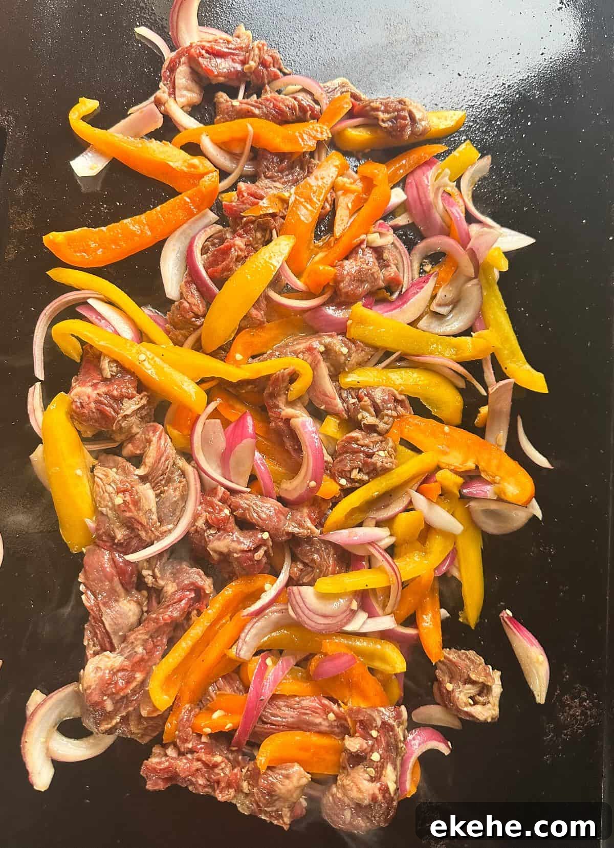 Fajita meat and peppers on griddle