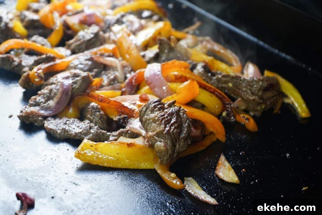 Fajita meat on flat top seared with caramelization 