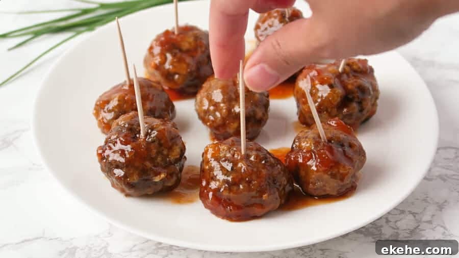 sweet & spicy apricot glaze being served as a sweet & spicy meatball appetizer with toothpicks