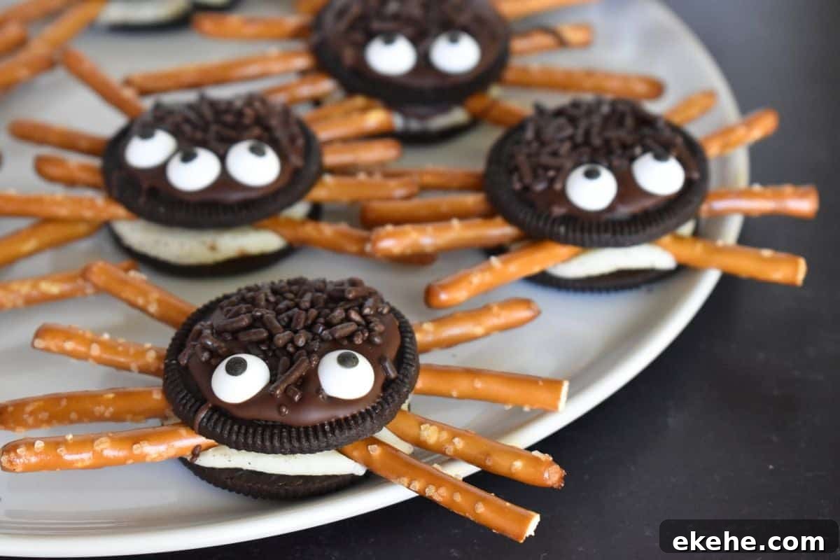 Oreo Cookie Spiders on a white plate on a black background.